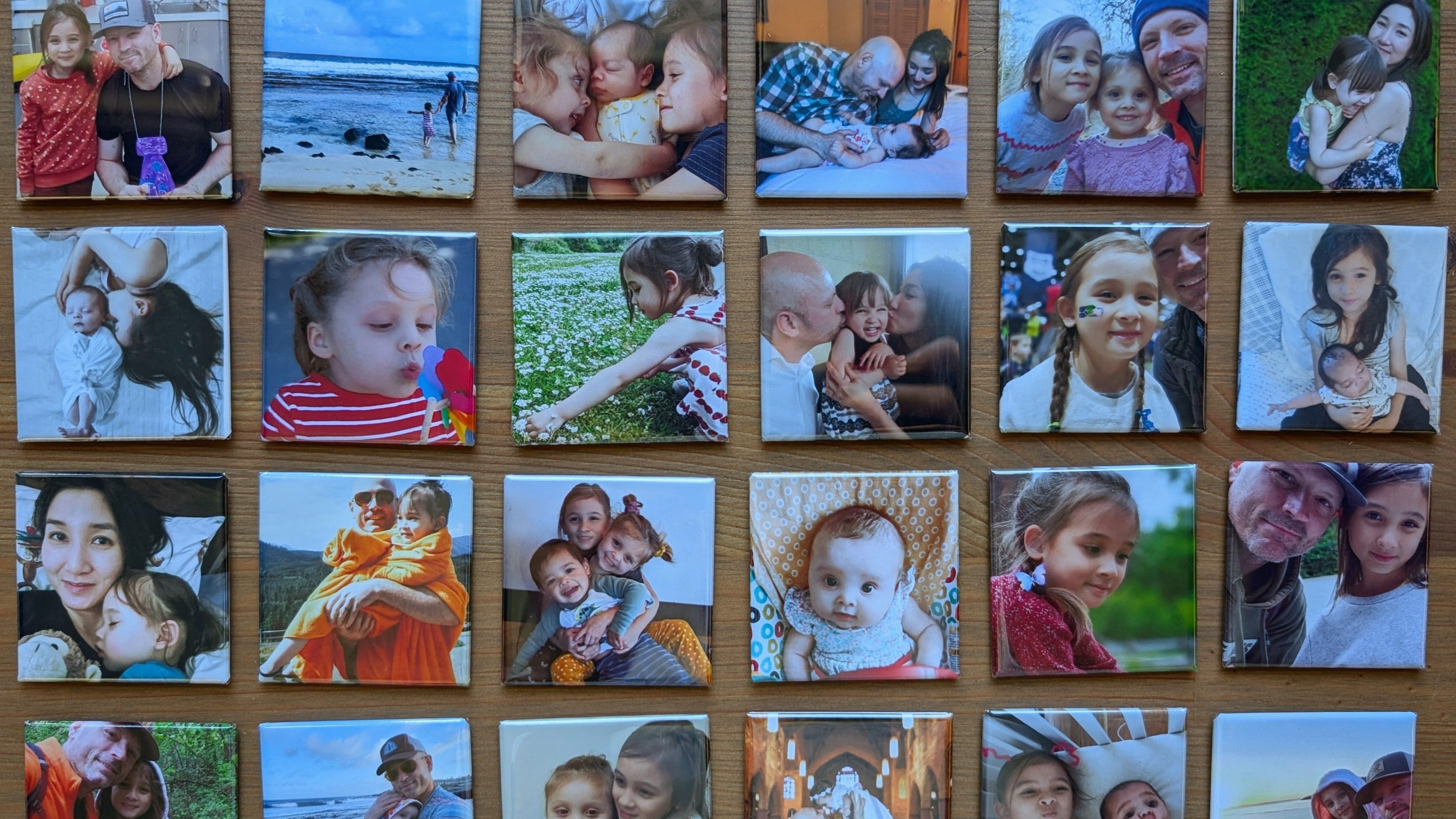 Collection of small square photos of people and children on a wooden surface.